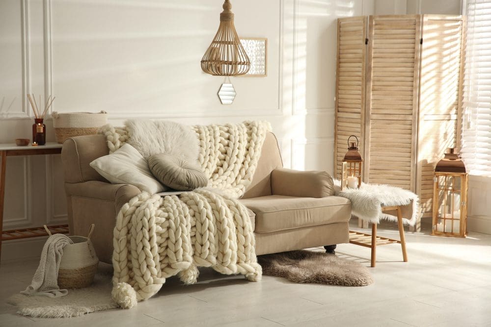 Cozy,Living,Room,Interior,With,Beige,Sofa,,Knitted,Blanket,And